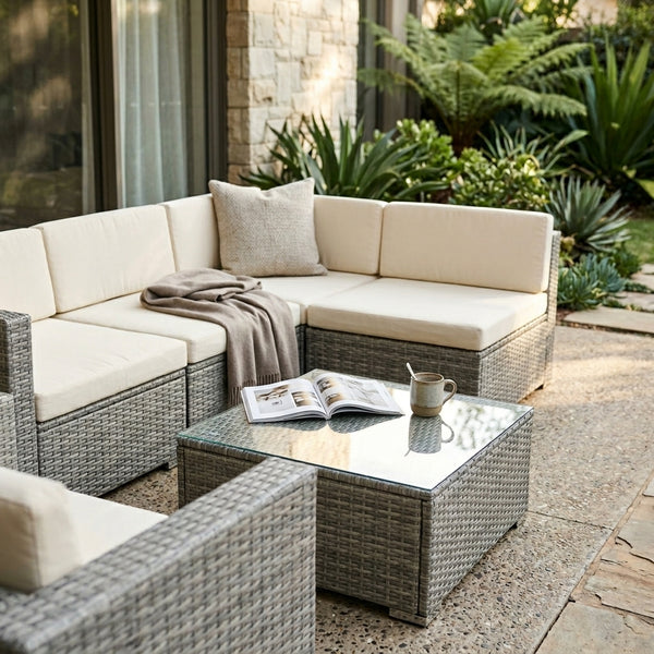 5-Piece Modular Rattan Outdoor Sectional Set arranged on a patio with a coffee table and decorative elements.
