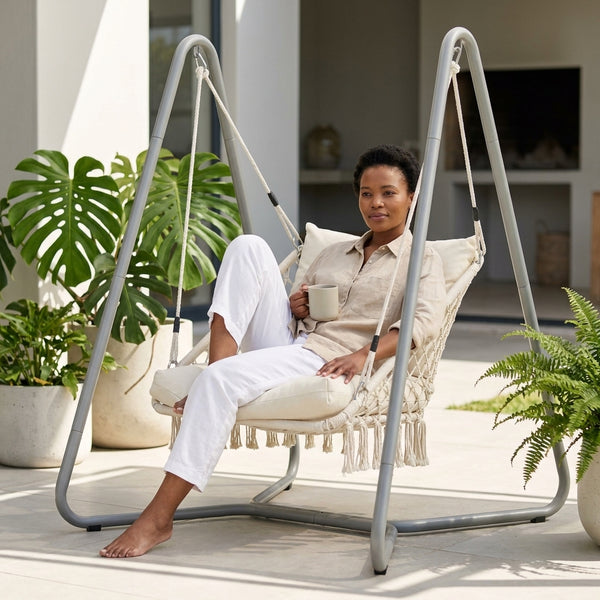 Macrame Hanging Hammock Chair with Steel Stand featuring a woman relaxing with a cup in a stylish outdoor setting.