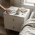 Modern Bedside Table with 2 Drawers beside a bed, featuring a cup of coffee and a book on top.