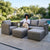 4 Piece PE Wicker Outdoor Patio Furniture in Grey featuring sofa, armchair, ottoman, and coffee table with a relaxed woman.
