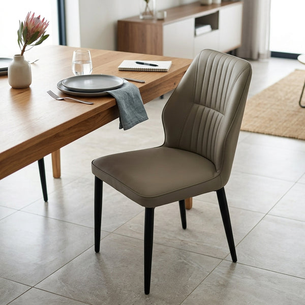 Modern Faux Leather Dining Chair with Channel-Tufted Back in a stylish dining room setting.