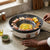 Uniform Heat Electrical Hot Pot and BBQ Grill Pan with grilled vegetables and seafood.