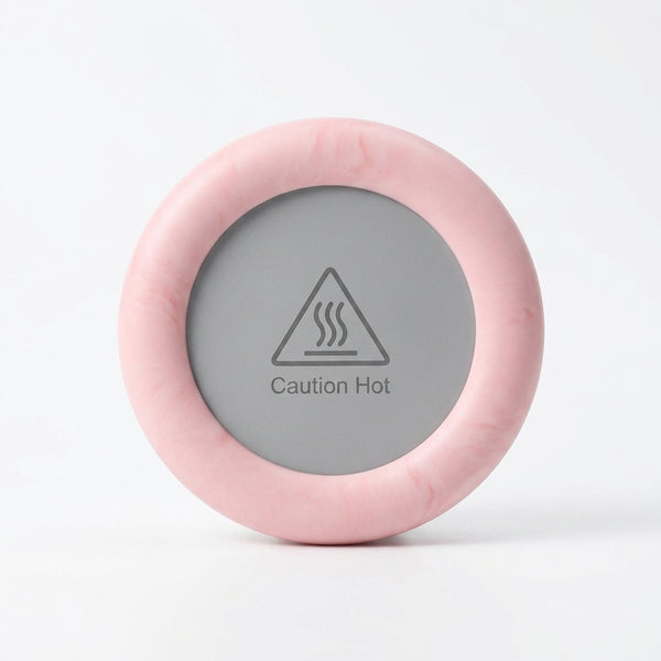 Thermostatic Heating Coaster in pink with a caution hot warning label on it