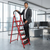 Man using a 6-Step Household Folding Ladder in a modern office setting, showcasing its stability and design. 7-Step Household Folding Ladder