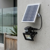 10W Solar Floodlight with solar panel mounted on wall for outdoor lighting.
