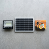 200W Solar Floodlight displayed with solar panel and packaging on a concrete surface