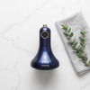 Electric Cupping Massage Device on a marble surface with a gray cloth and a green plant nearby.