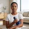 Woman using the Electric Cupping Massage Device at home in a stylish living room setting.