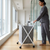 Collapsible Laundry Basket with Wheels in a modern home setting, held by a person in casual attire.