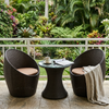 3-Piece Rattan Outdoor Bistro Set featuring two chairs and a table on a balcony with lush greenery.