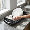 2-Tier Kitchen Dish Drying Rack with Utensil Holder with plates and cups on kitchen counter.