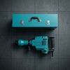 Corded Hammer Power Tool with Carrying Case on a gray surface, showcasing the tool and its protective case.