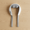 Wearable Shoulder and Neck Massager resting on a wooden surface, designed for hands-free massage sessions.