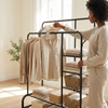 120cm 3-Tier Double-Rail Drying Rack With Wheels holding neatly arranged clothes and towels.