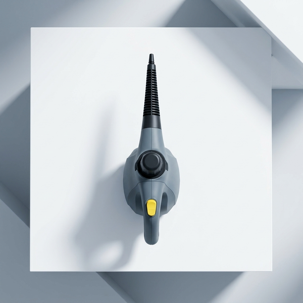 Top view of a 1200W Handheld Steam Cleaner on a white surface, showcasing its compact design and efficient nozzle.