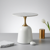 Modern Round Marble-Style Side Table with a circular marble top and unique gold pedestal base, elegantly styled in a modern setting.