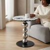 Round Marble-Look Coffee Table with Decorative Metal Base, featuring a sleek marble top and stylish metal support.