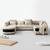 Modern Curved Sectional Sofa in a stylish living room setup with cream upholstery and sleek black accents.