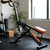 Adjustable Folding Fitness Exercise Machine in a home workout space with padded seat and handles.