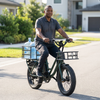 Man riding Electric Utility Bike with Front & Rear Carriers transporting water bottles on front and rear carriers.
