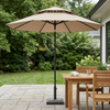 2 Metre Beach & Courtyard Umbrella providing shade over a wooden dining table in an outdoor garden setting.