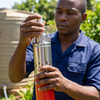 A person handling a 24V 50M DC Submersible Water Pump, showcasing its stainless-steel design and construction.