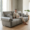 Comfortable living space featuring a woman relaxing on a stylish 3-Seater Sofa with decorative pillows.