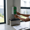 Hand operating the controller for 48V 1500W Wind Turbine with Solar MPPT Controller and battery setup.