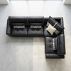 L-Shaped Sectional Sofa with black cushions and decorative pillows in a modern living room setting.
