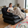 Woman relaxing on a 5-in-1 Inflatable Air Couch while reading a book with a blanket.