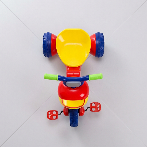 Kids First Pedal Tricycle Ride-On Toy in red and yellow with wide wheels and green handlebars, perfect for toddlers.