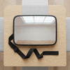 Rear Seat Baby Car Mirror with Adjustable Strap on wooden surface, showcasing its wide reflective surface and strap design.