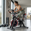 Indoor Spin Bike with Digital Display & Flywheel in a modern home gym setting.