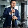 Man using Electric Wine Opener Set with Bottle Accessories in a modern kitchen setting.