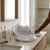 Toddler Toilet Training Seat with Handles placed on a bathroom counter next to toiletries and a towel.