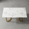Modern White Marble-Look Dining Table with Gold Legs on a sleek surface.
