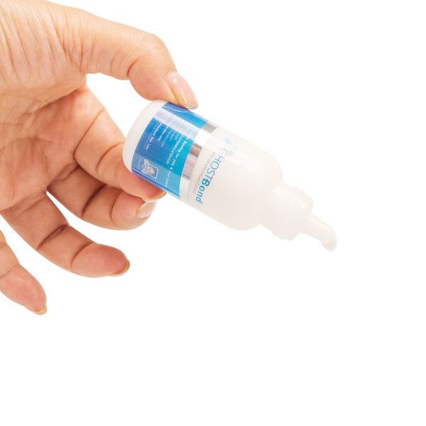 Hand holding a bottle of Extra Moisture Resistant Lace Wig Glue for a secure hold.