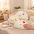 Dumpling Plush Throw Pillow set on a cozy sofa, showcasing cute, colorful faces and soft textures ideal for decoration.