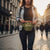 Woman wearing a Camouflage Multi-Pocket Side Bag in a city setting, showcasing its compact design and functionality.