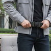 Person adjusting a Utility Tactical-Style Belt for a secure fit during outdoor activities.