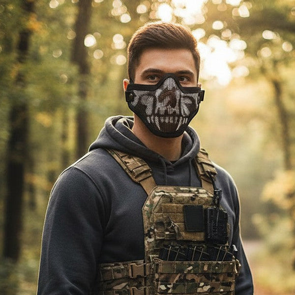 Skull Print Face Mask worn by a man in a tactical outfit, showcasing a distinctive skull graphic in a forest setting.