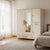 Multi-Compartment White & Natural Oak Wardrobe Armoire in a modern bedroom setting with soft lighting.