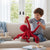 A child plays with a Realistic Octopus Plush Toy, enjoying its lifelike details and vibrant color in a cozy living room setting.