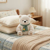 23cm Plush Polar Bear sitting on a bed, featuring a green scarf and friendly expression, perfect for cuddling.