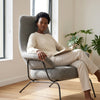 Zen Lounge Chair featuring a woman reading comfortably in a modern, minimalist design with a sleek frame and spacious seat.