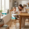 A mother and toddler enjoying mealtime in a Summer Infant Sit in Style Booster Seat at a dining table.