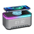 Smart Multifunction Alarm Clock with Bluetooth Speaker showing a phone charging wirelessly on top.