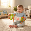 Baby playing with Lobster Accordion Musical Baby Toy in a bright room, smiling and exploring the toy.