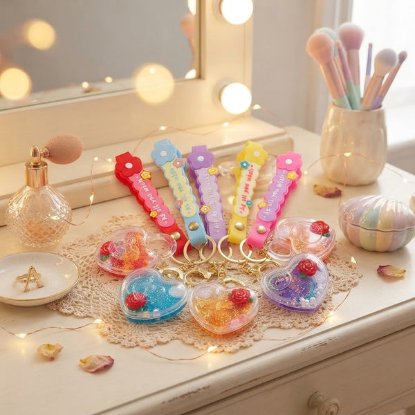 Heart-Shaped Liquid Glitter Keychain displayed with colorful keychains and decorative elements on a vanity table.