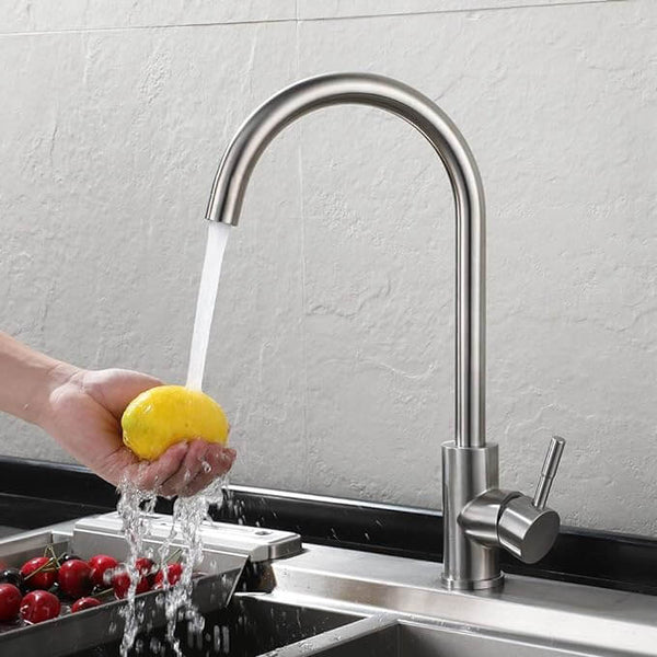 Stainless Steel Turn Sink Tap in action, showcasing water flow while washing a lemon.